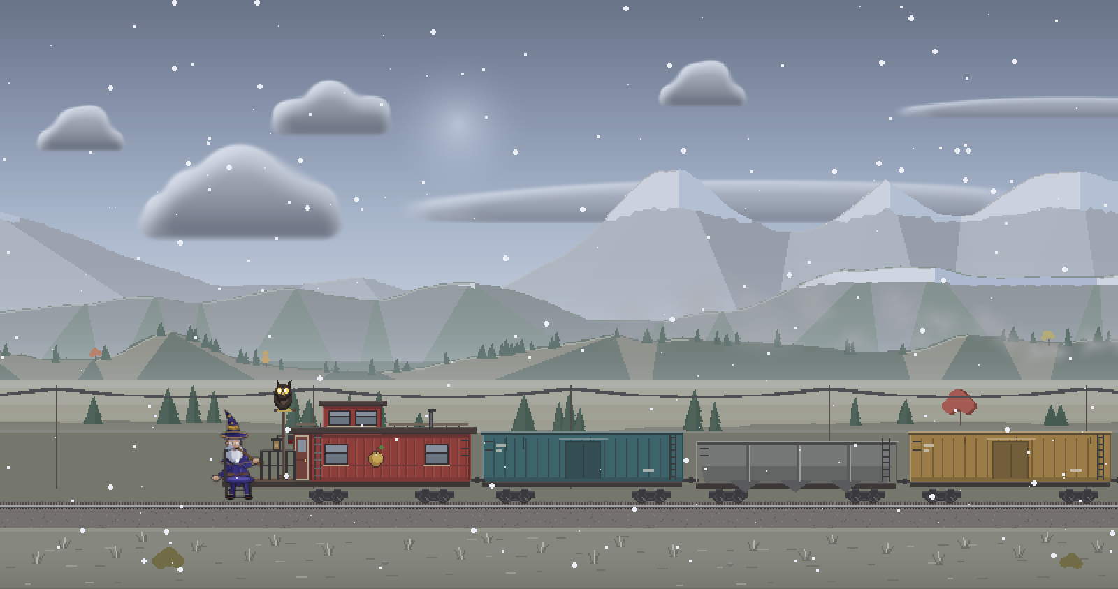 The train in falling snow below the mountains.