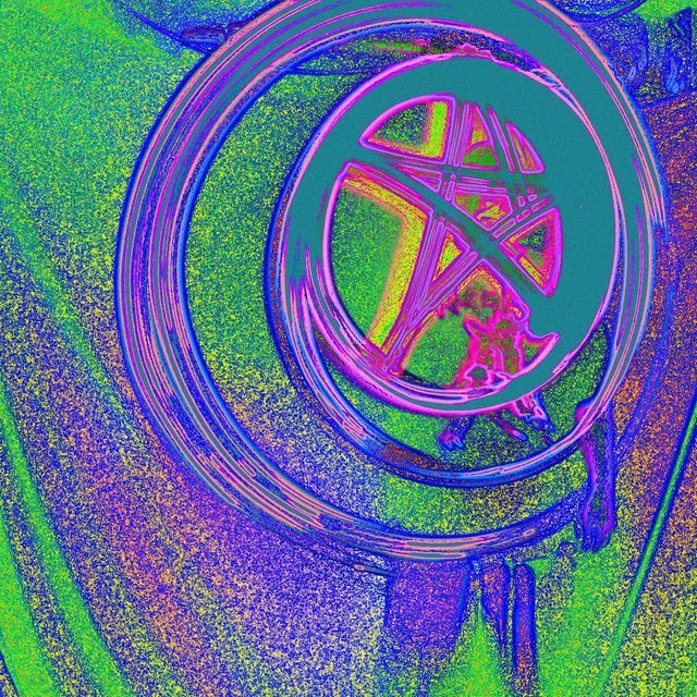 The same photograph in grainy violet, green and orange, with the rings and the star outlined in blue and pink.