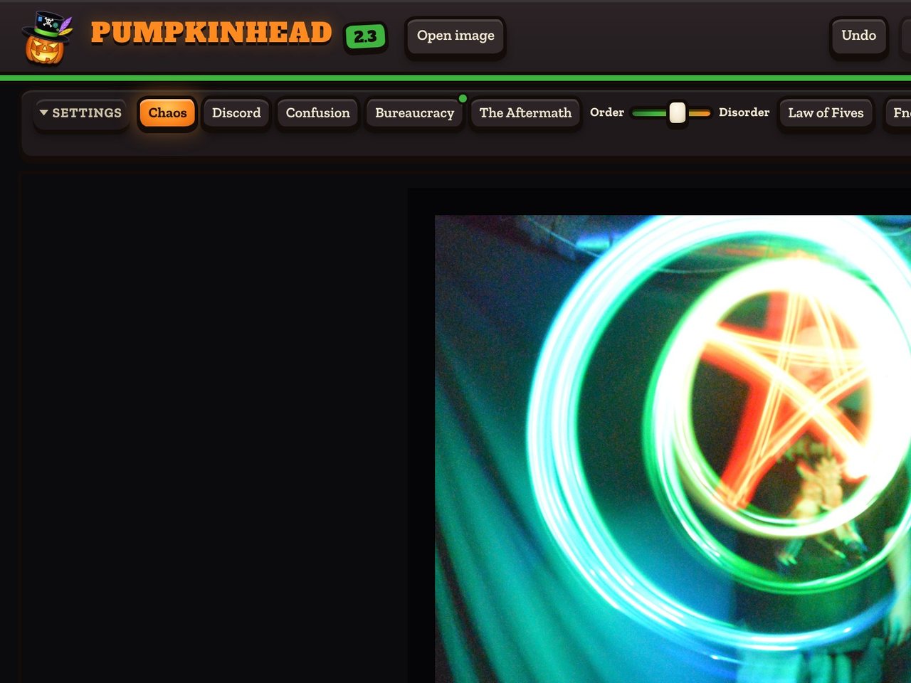 The top left of Pumpkinhead: the pumpkin logo, the name, and the Open image button, above a photograph of rings of light on the dark bench.